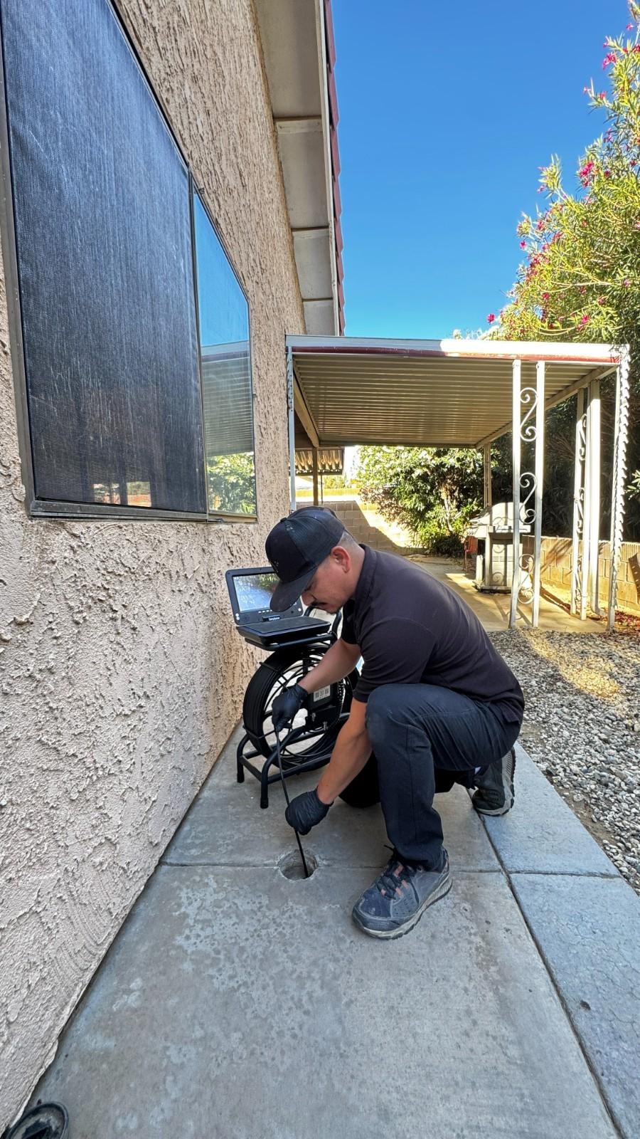 Plumber running a drain camera inspection