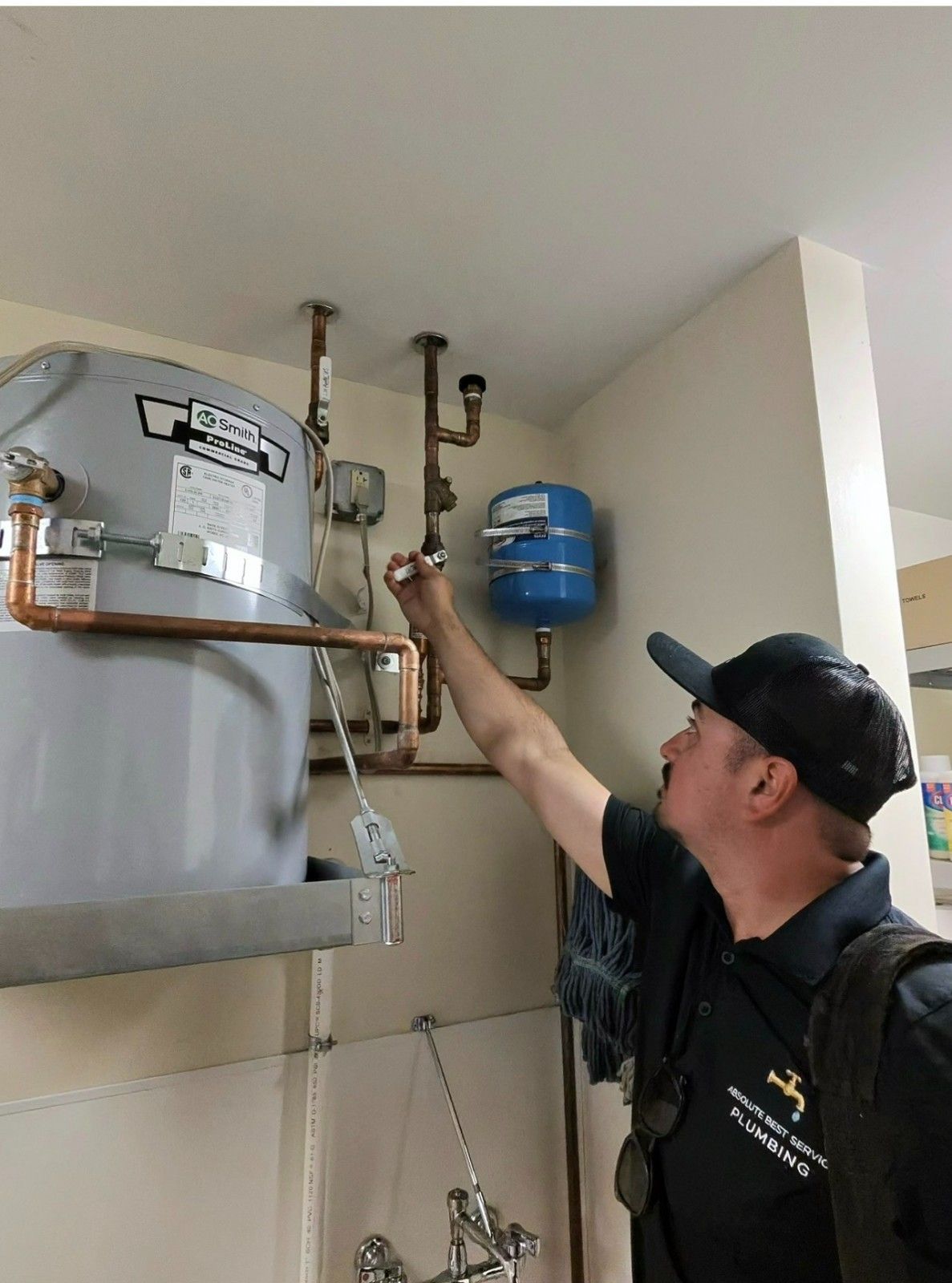 Absolute Best Service Plumbing technician installing a commercial water heater